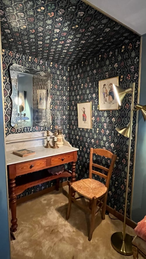 Elegant bathroom at Domaine de Blanvatel B&B in Saint Pierre en Auge featuring dark floral wallpaper and wooden vanity