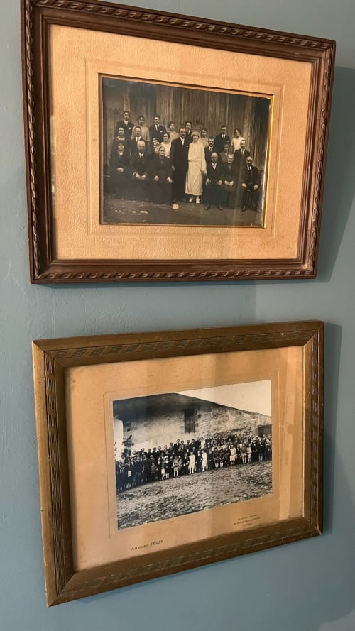 Two framed vintage family group photographs at Domaine de Blanvatel, a French bed and breakfast in Saint-Pierre-en-Auge