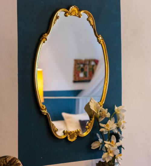 Miroir aux ornements dorés à Casa Peregrinando B&B à Navarrete, décoré de fleurs blanches