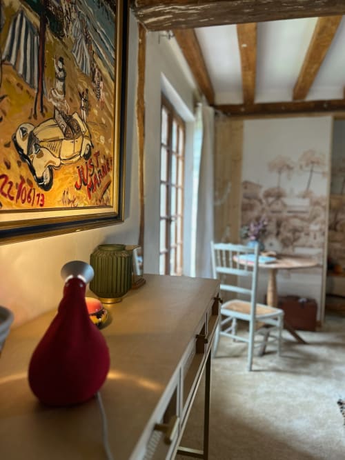 Elegant hallway at Domaine de Blanvatel, Saint Pierre en Auge, with framed artwork, wooden beams, and rustic French décor