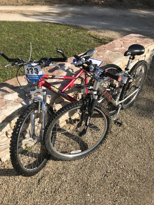 Three bicycles parked at Les Maisons de Chamirey cottage in Mercurey, France, with bike garage amenities.