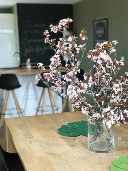 White and brown dried flowers in glass vase on wooden table at Les Maisons de Chamirey cottage, Mercurey