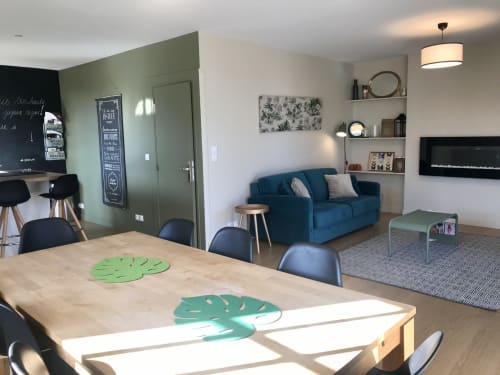 Modern cottage living room at Les Maisons de Chamirey with blue sofa, dining table, and shelving in Mercurey