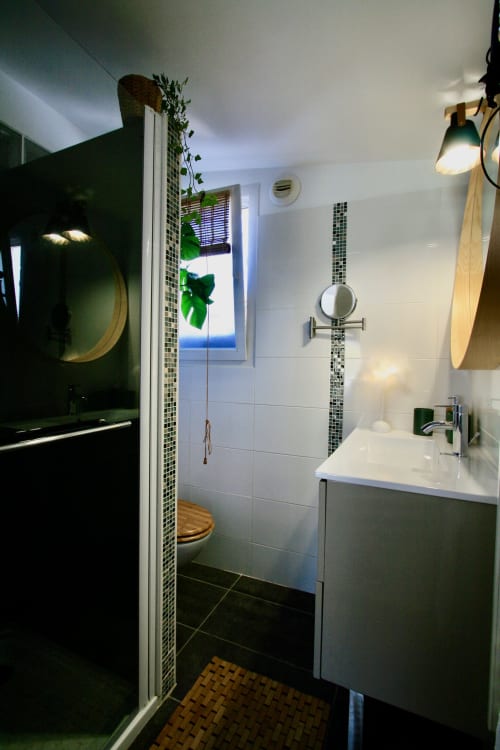 Salle de bains moderne de la villa Tiny Harmony à Venelles avec douche, carrelage blanc, accents verts et lumière naturelle