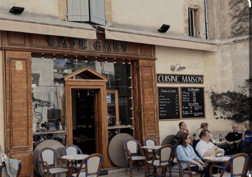 Café Gaby storefront in Lourmarin with outdoor seating and patrons enjoying refreshments