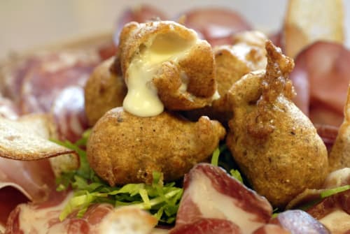 Fried potato croquettes with melted cheese and prosciutto at Al Dos hotel in Livigno