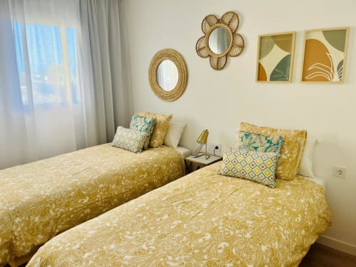 Twin beds with gold damask bedding in Family Suite 401 at Sunset ocean view hotel, Arguineguín