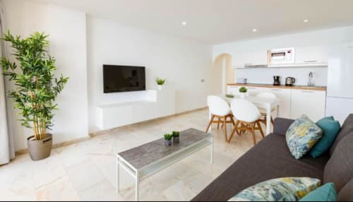 Modern 1-bedroom apartment in Arguineguín with open-plan living, kitchen, dining area, and sea view balcony