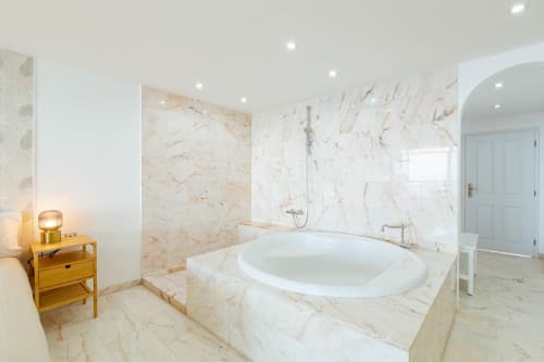 Luxurious marble bathroom in Sunset ocean view suite in Arguineguín with soaking tub, walk-in shower, and modern fixtures