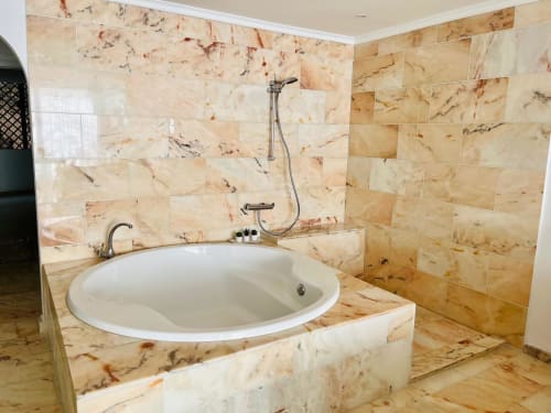 Luxurious marble bathroom with circular soaking tub and rainfall shower in Arguineguín ocean view studio