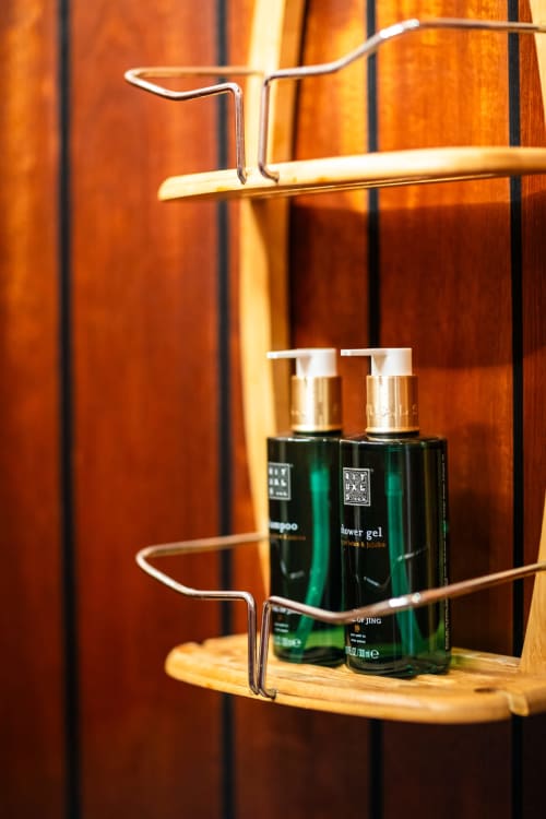 Wooden bathroom shelves with toiletries at Domaine De Campagnac, Carsac-Aillac