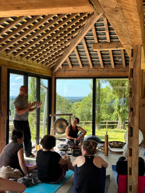 Yoga class in wooden pavilion at Domaine de Blanvatel, Saint Pierre en Auge, with countryside views