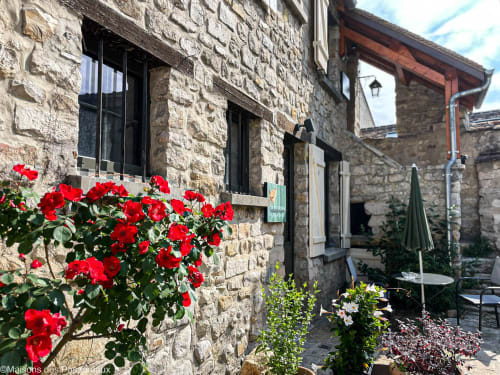 Ancienne maison en pierre rénovée avec terrasse et plantes en pot au Vaudoué, pays de Fontainebleau, parc régional du Gâtinais