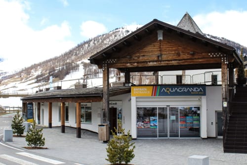 Aquagranda entrance at Al Dos hotel in Livigno, Italy with snowy mountains and modern lodge architecture