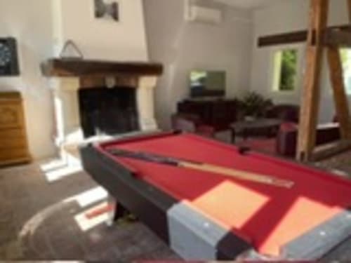 Red billiard pool table in lounge area at Les Gites De Flaubert, Le Heron France