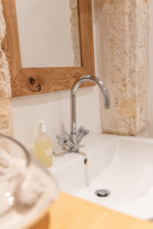 Modern bathroom sink with chrome faucet at Le Prieuré Notre-Dame in Montfrin, France