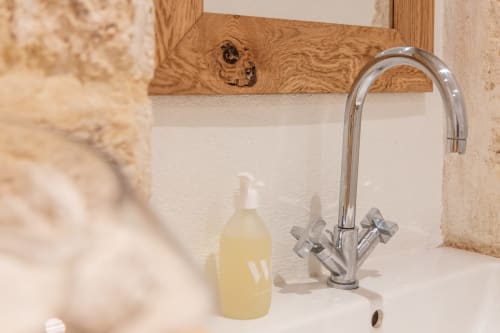 Modern bathroom sink with chrome faucet and soap dispenser at Le Prieuré Notre-Dame bed and breakfast in Montfrin