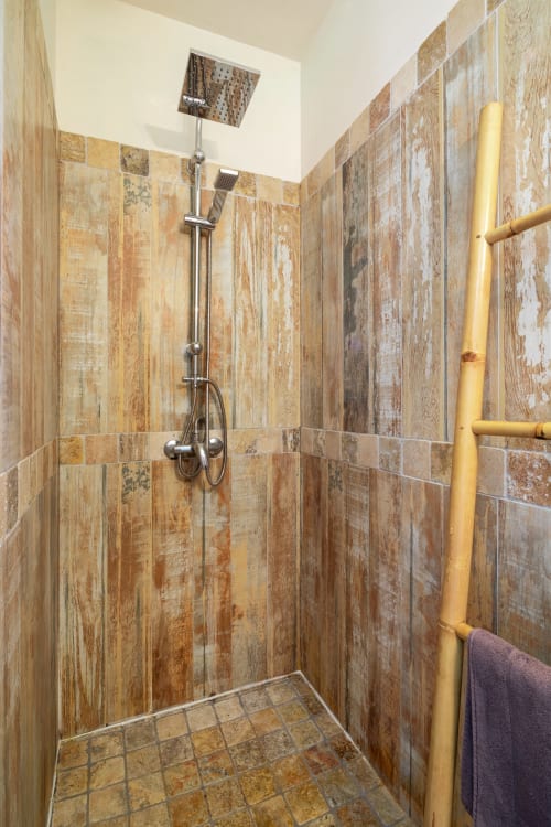 Moderne inloopdouche met houtlook tegels en regendouche in gîte Domaine De Campagnac