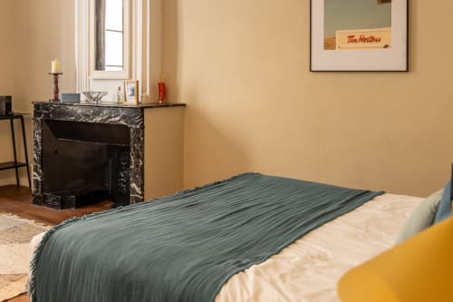 Elegant Louis Room at Le Prieuré Notre-Dame with fireplace, beige walls, and green bedding