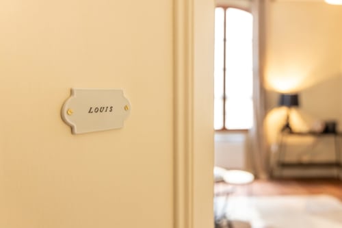Louis Room door plaque at Le Prieuré Notre-Dame in Montfrin, France