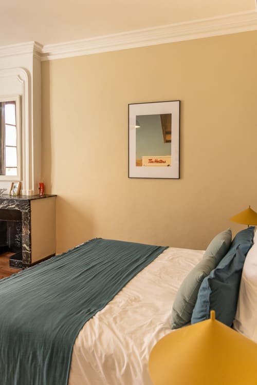Louis Room at Le Prieuré Notre-Dame B&B in Montfrin, FR, with bed, fireplace, and yellow accents