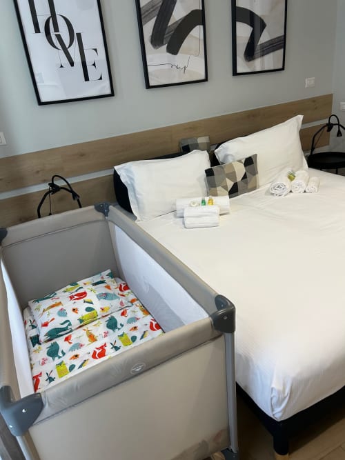 Camera da letto moderna a Casa Lounge Istria, Cagliari con letto matrimoniale, culla e opere d'arte contemporanea