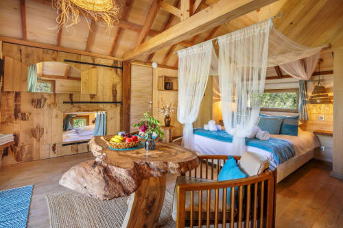 Béquia room at Domaine De Campagnac in Carsac-Aillac with wooden beams, canopy bed, garden view, and rustic furnishings