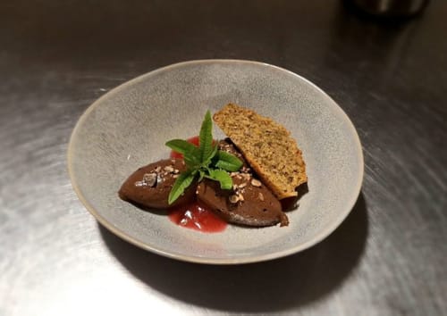 Gourmet chocolate dessert with crispy almond tuile and fresh mint at Domaine de l'Oie Rouge, Loire Valley