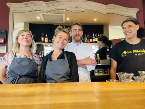 Smiling staff members behind bar at Domaine de l'Oie Rouge, Loire Valley hospitality venue near Angers, France