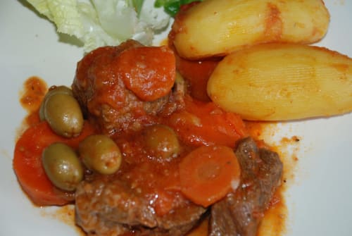 Braised meat with roasted potatoes, olives and red sauce at Domaine de l'Oie Rouge table d'hôtes, Gennes-Val-de-Loire