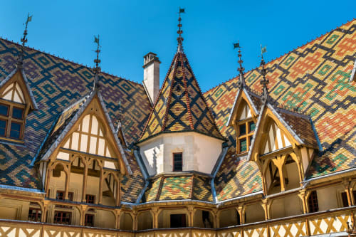 Colorful tiled roofs and half-timbered architecture of Gites bo B&B in Saint-Romain, France