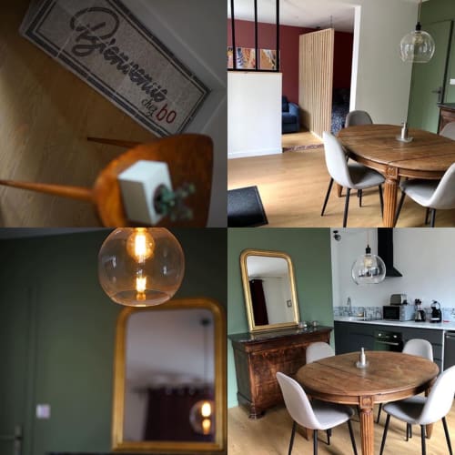 Appartement Le Boisé aux Gites bo : table à manger, luminaires suspendus, murs verts, mobilier bois et décoration contemporaine