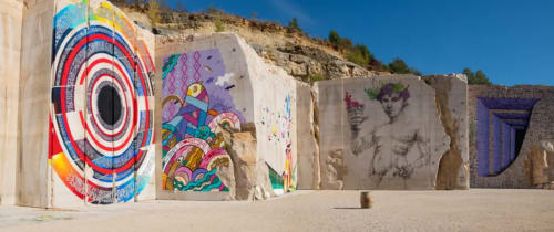 Colorful street art murals on stone structures at Gites bo in Saint-Romain, France
