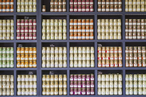 Wine bottles organized in wooden display cabinet at Gites bo bed and breakfast in Saint-Romain, France