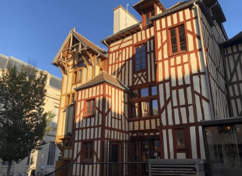 Bâtiments à colombages du Moyen Âge de l'hôtel Le Paillot de Montabert à Troyes, façades rouges et crème sous un ciel bleu