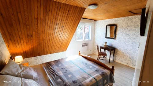 Chambre spacieuse à Loc'Maria Belle Île en Mer avec plafond en bois, vue sur jardin, bureau et décoration traditionnelle