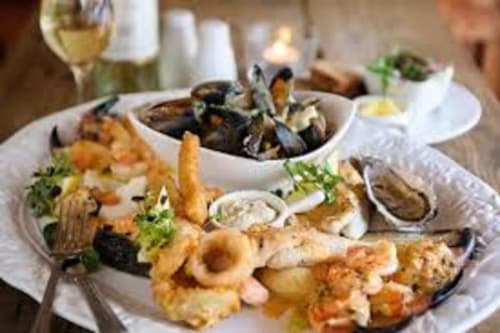 Fresh seafood platter at Seabrook Lodge restaurant in Clifden, Galway featuring mussels, squid and oysters with white wine