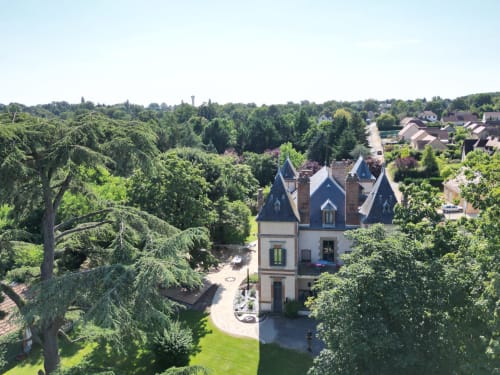 Château Ségot luxury B&B in Neuilly-le-Réal, surrounded by lush greenery and mature trees