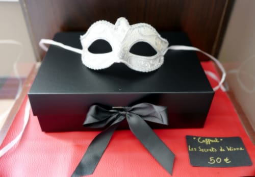 Masques vénitiens blancs présentés sur coffret de jouets érotiques à Les Secrets de Winna, hôtel romantique, Deux-Sèvres