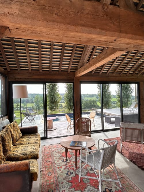 Domaine de Blanvatel lounge with wooden beams, countryside views, and pool access in Saint Pierre en Auge