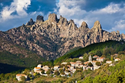 Alma Rossa hotel nestled in Lecci village with dramatic rocky peaks and Mediterranean landscape