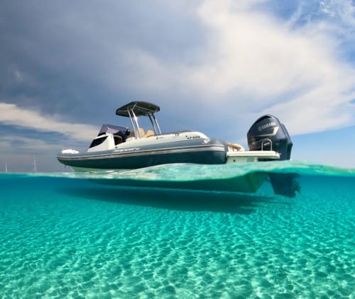 Speedboat with Yamaha engine anchored in crystal-clear turquoise waters near Lecci, Corsica