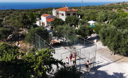 Villa Freedom B&B tennis court with guests in Kokkino Chorio, Crete, sea view backdrop