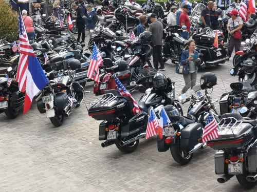 Motorcycle rally gathering with American flags near Isigny-sur-Mer, France