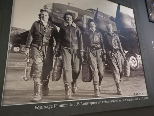 Female US Army pilots in flight suits standing before B-17 bomber, 1944. Historical aviation image at Au Gite d'Isigny,