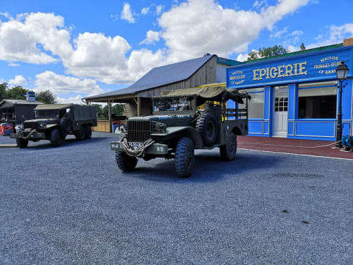 Historic military jeeps parked at Au Gite d'Isigny, a charming bed and breakfast in Isigny-sur-Mer, France.