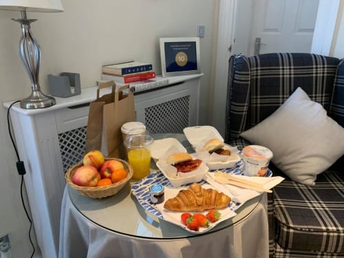 Hotel welcome tray with fresh fruit, pastries, juice and treats at Grapevine Studio, Waterbeach Cambridge