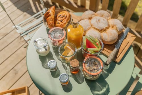 Breakfast served on a terrace with forest views | Treehouse Stay in Central France