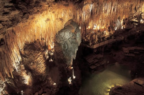 Illuminated stalactites and stalagmites in cave chamber near Carsac-Aillac, Domaine De Campagnac B&B attraction