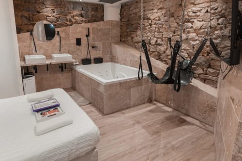 Découvrez la Love Room 3, une suite romantique idéale pour une escapade en couple. Avec ses magnifiques murs en pierre apparents, cette chambre offre une ambiance chaleureuse et authentique. Profitez d'une double vasque moderne et d'un grand écran TV avec Netflix pour vos soirées détente. Le clou du séjour ? Une superbe baignoire à balnéothérapie pour deux, parfaite pour un moment de relaxation absolue. Réservez la Love Room 3 et vivez une expérience inoubliable avec sa superbe balançoire érotique !